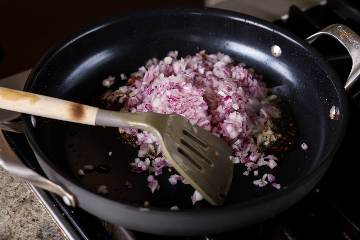 adding onion to the pan