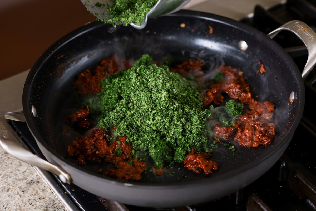 adding frozen spinach to the pan