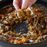 dipping flatbread into chicken saagwala
