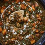 piece of flatbread in the pan of chicken saagwala