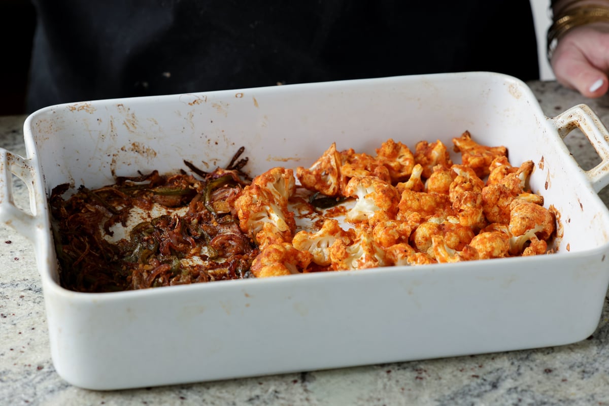 aromatics mixed with the spices in the pan