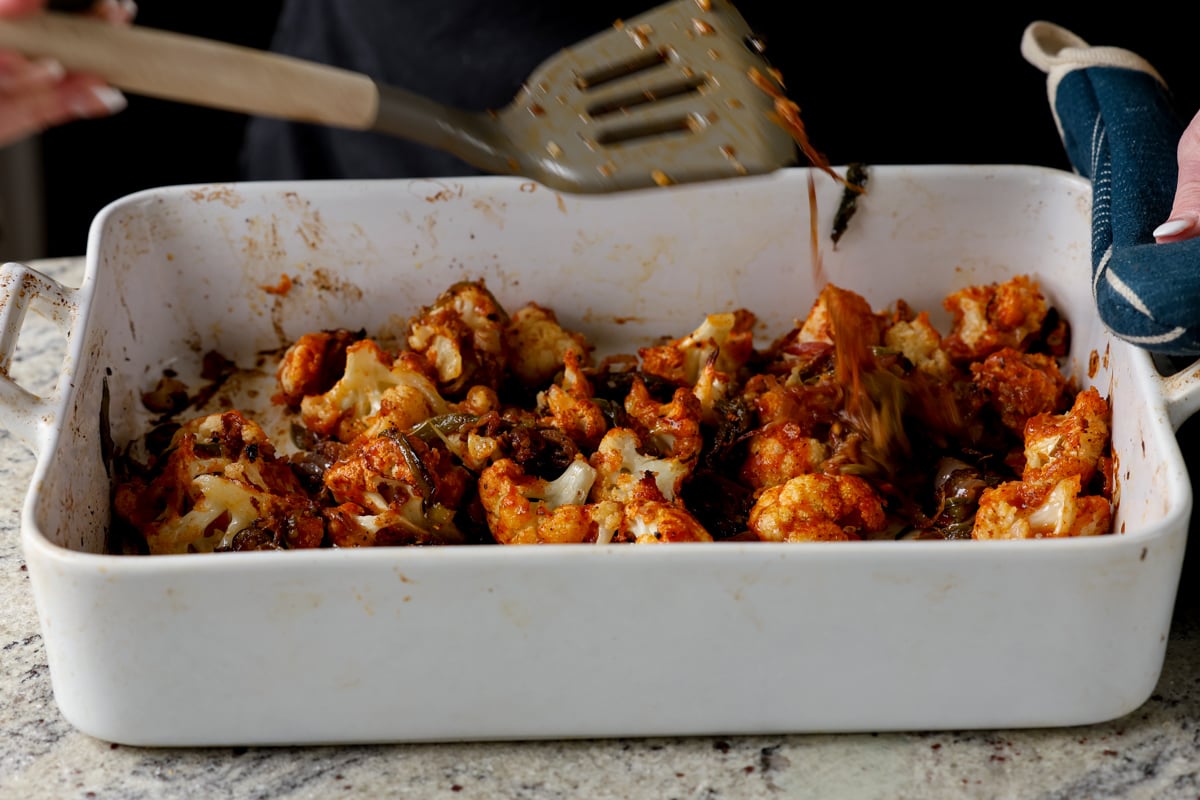 cauliflower and aromatics in the pan after baking