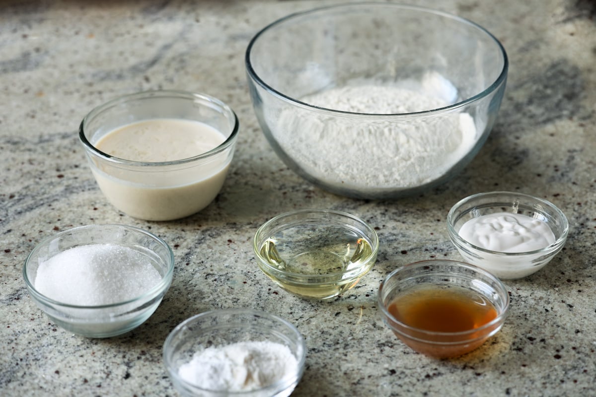 vegan lemon cake ingredients in bowls on the kitchen counter