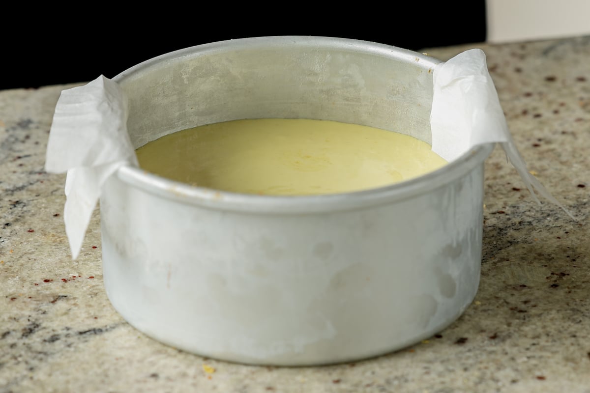 adding frosting to the first cake layer