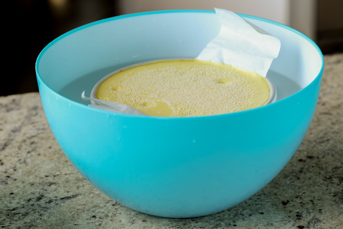 adding chilled cake to the bowl of hot water