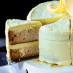 removing a slice of vegan lemon cake from the cake stand