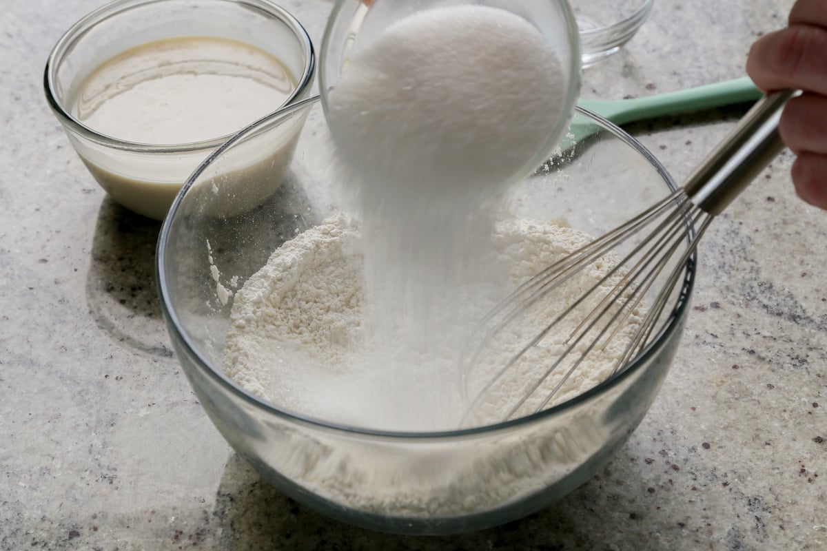 adding dry ingredients to the mixing bowl