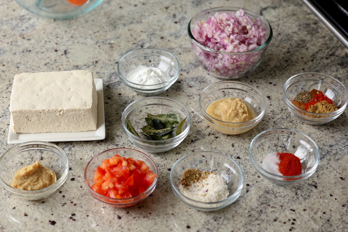 madurai chicken curry ingredients in bowls on the kitchen counter