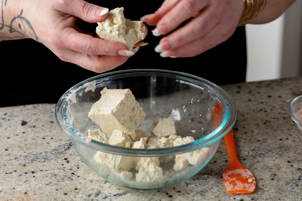 tearing the tofu into pieces
