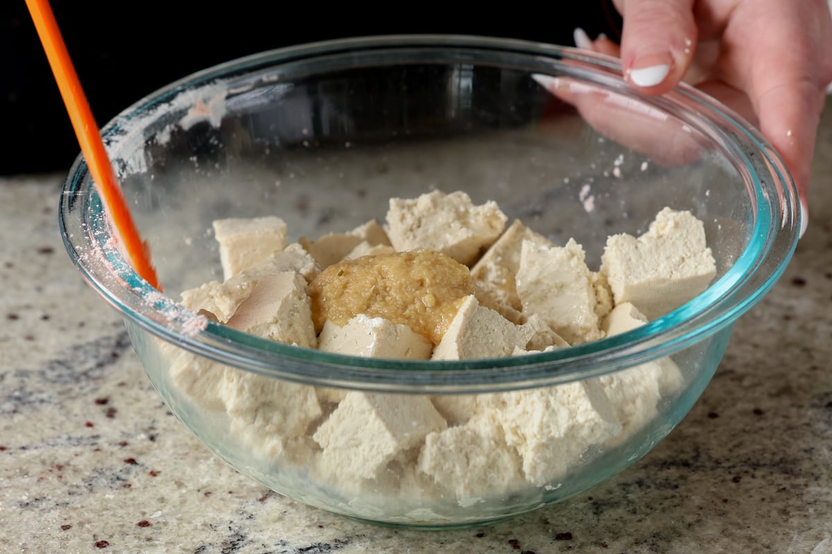 adding ginger garlic paste to the tofu