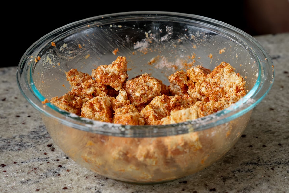 bowl of tofu coated in cornstarch and spices