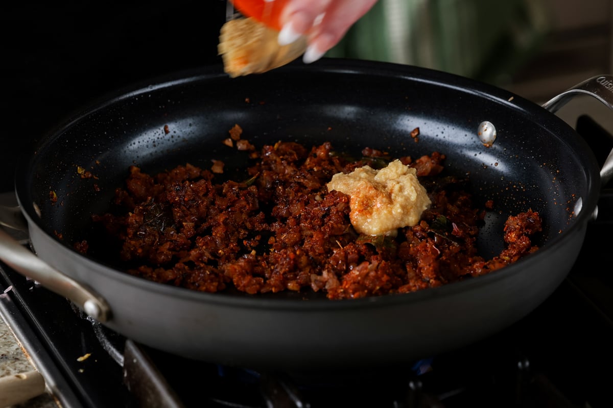 adding ginger garlic paste to the pan
