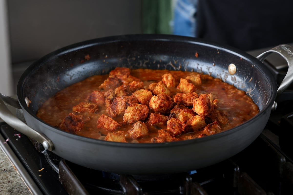 tofu "chicken" in the pan of curry sauce