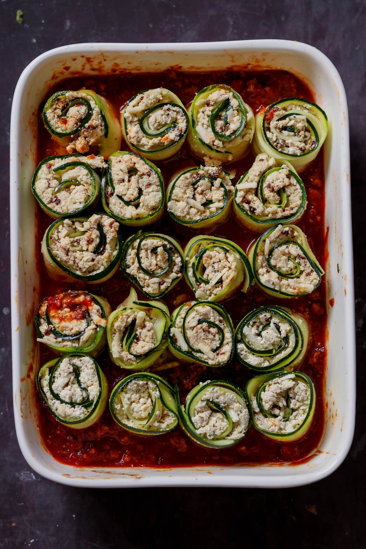 zucchini rolls in the baking dish before baking