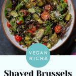 shaved Brussels sprouts salad in a bowl with tomatoes, lettuce, and walnut crumble, text overlay