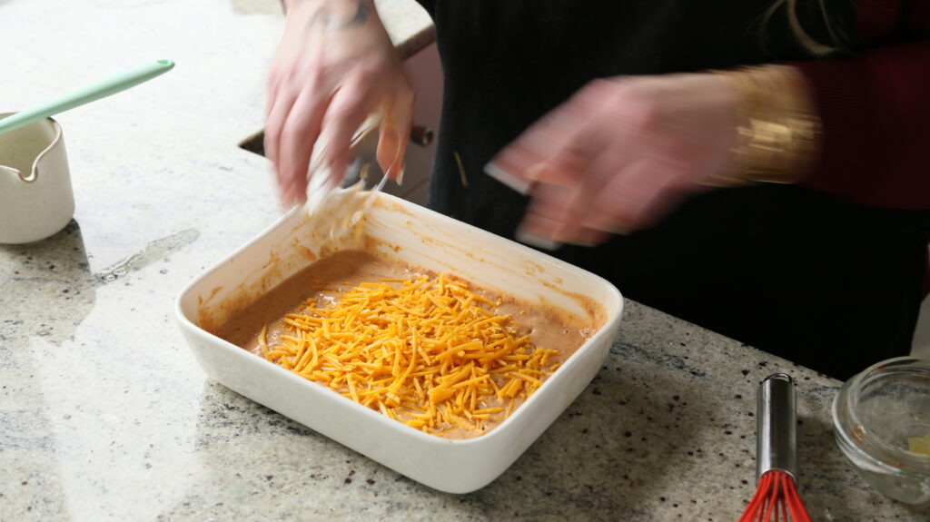 folding the cheese into the smoky mac and cheese sauce