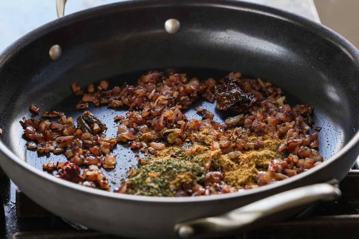 adding spices to the cooked onions