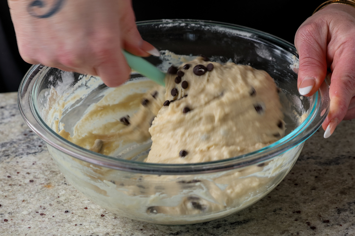 folding the chocolate chips into the muffin batter
