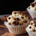 chocolate chip muffin on a wooden cutting board