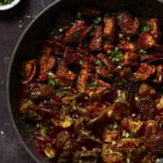 malabar eggplant in the pan with toppings next to it