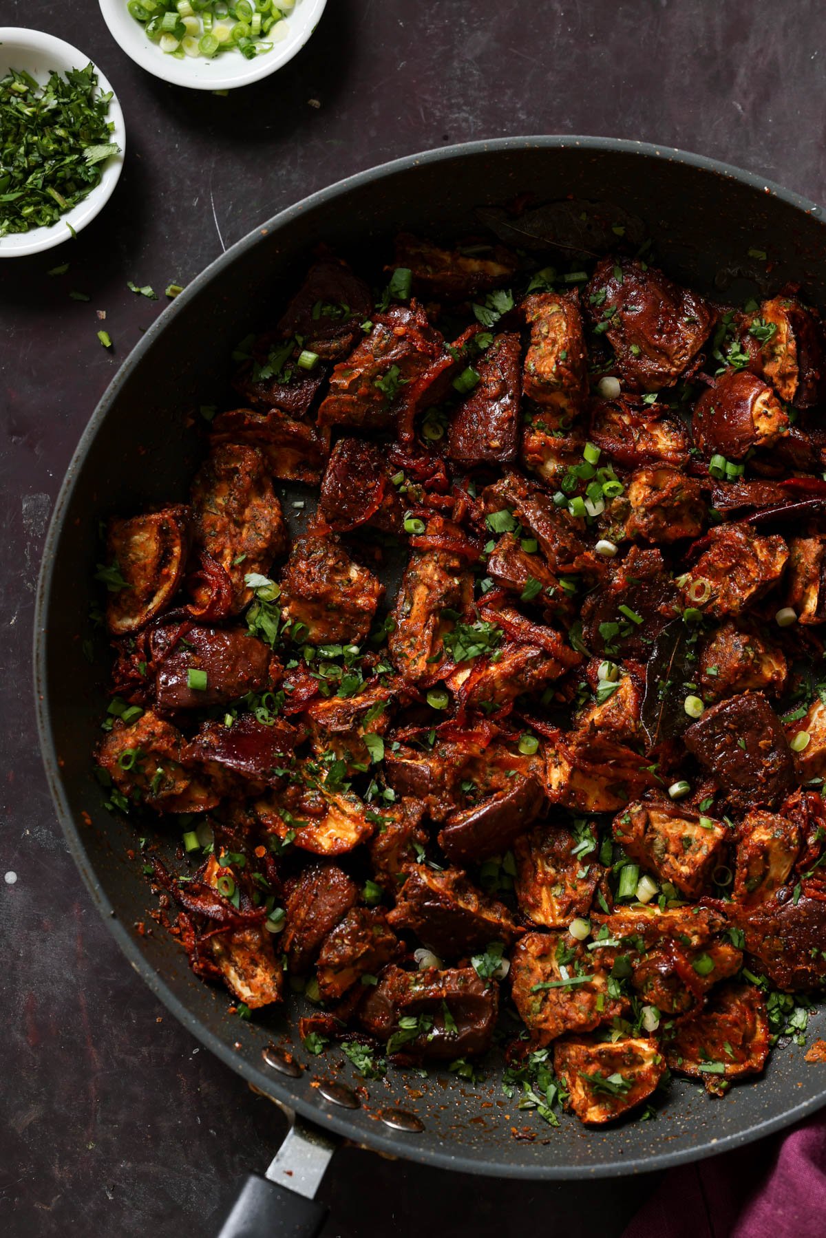 malabar eggplant in the pan with toppings next to it