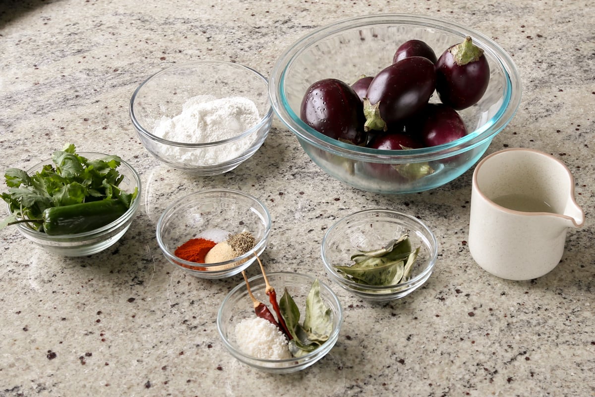 eggplant, spices, and other malabar eggplant ingredients on the counter