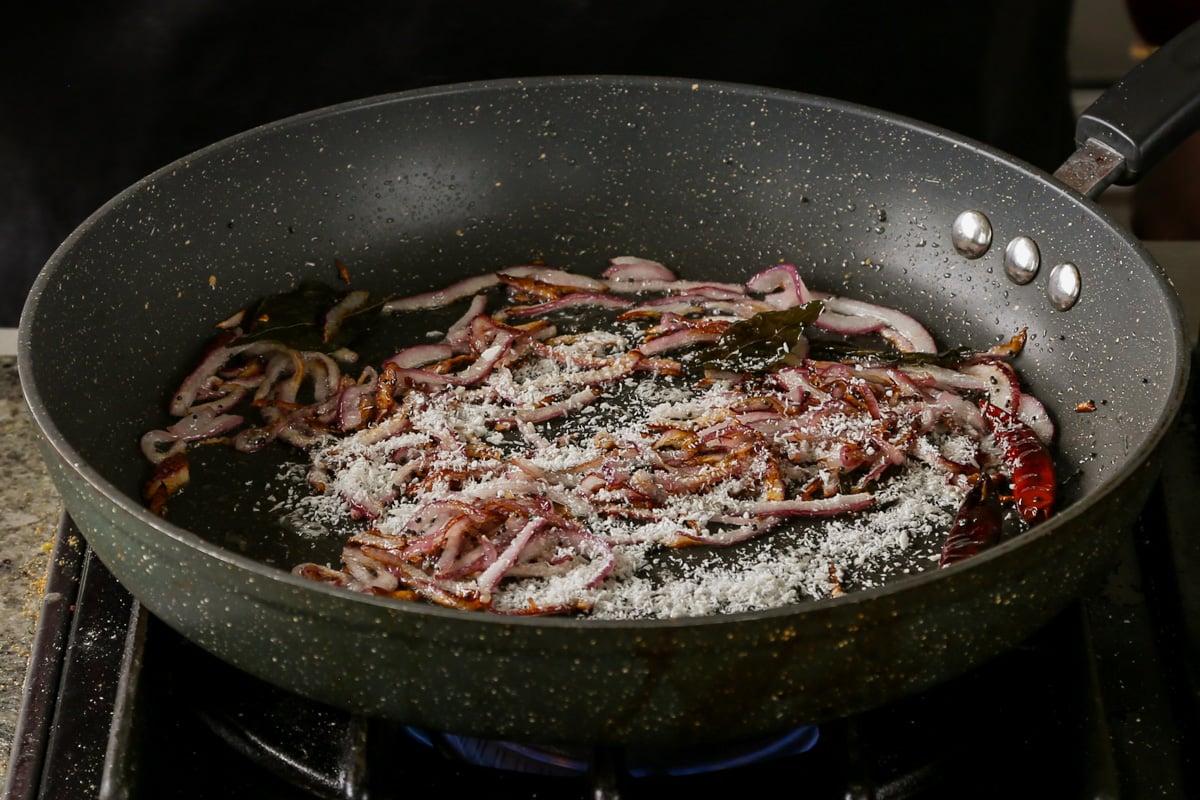 adding coconut to the pan