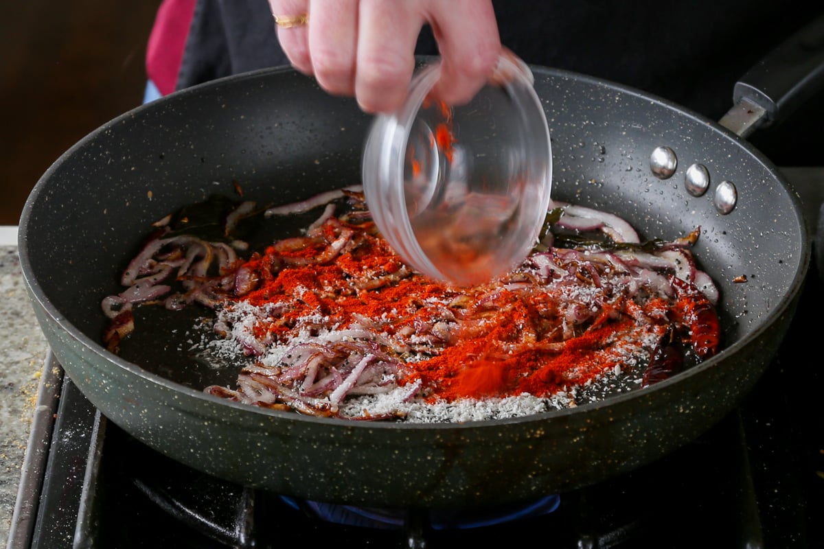 adding ground spices to the pan