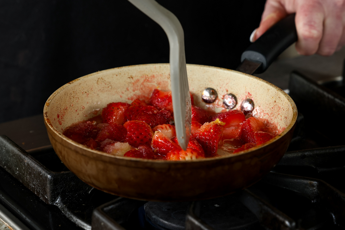 mashing the berries with a spatula
