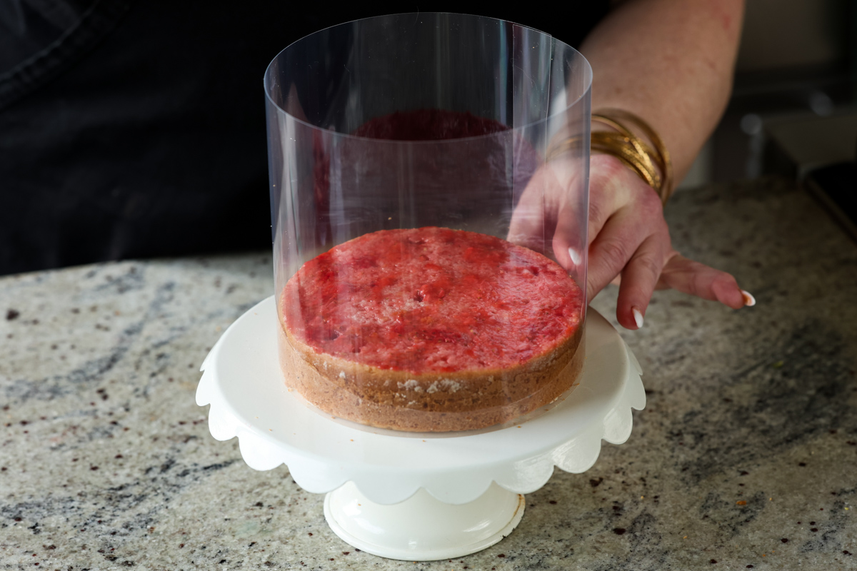 putting the cake collar around the cake