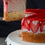 cutting a slice of strawberry mousse cake