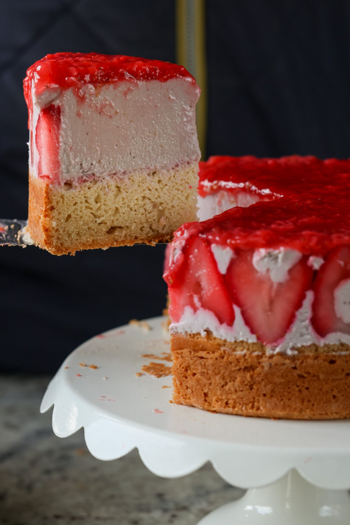 cutting a slice of strawberry mousse cake