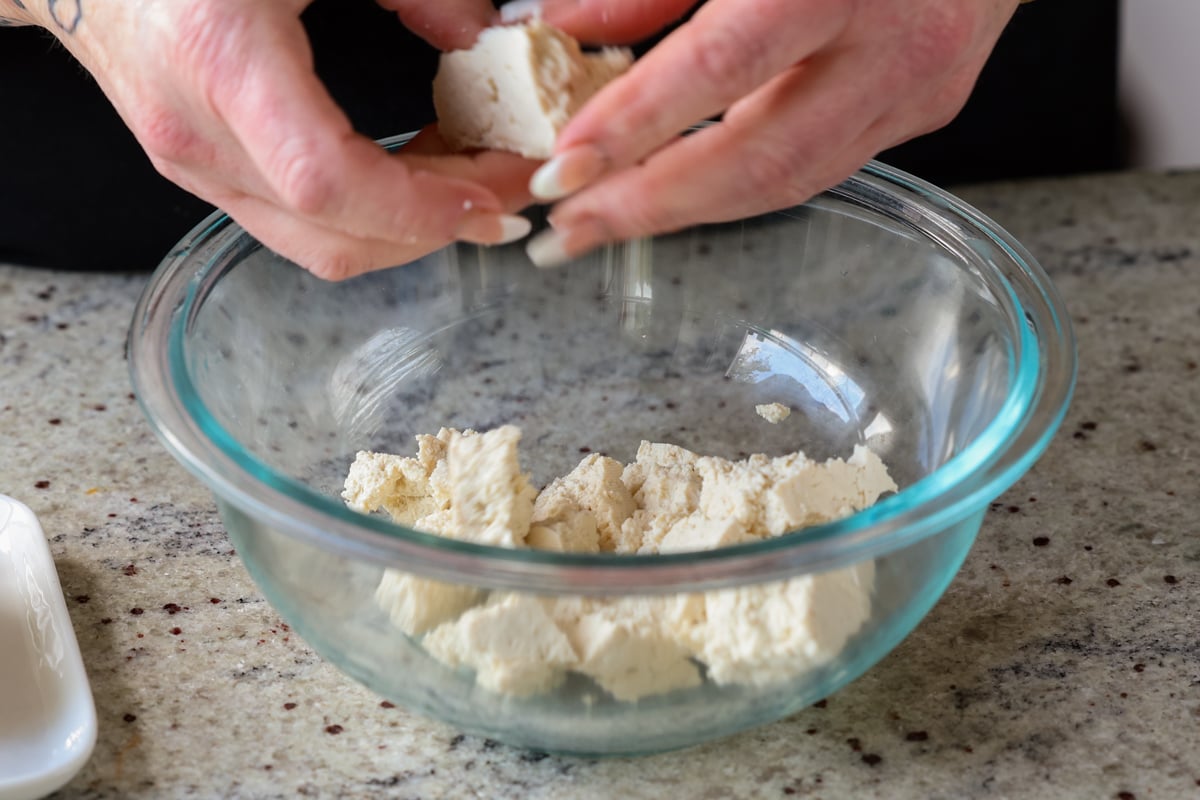 tearing up the tofu into pieces