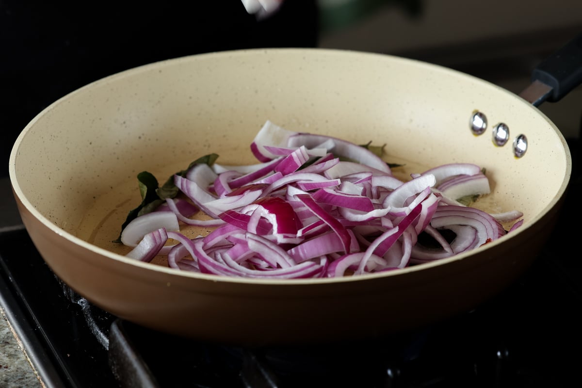 adding onion to the pan