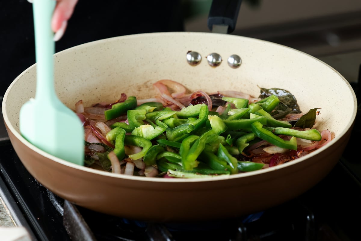 adding bell pepper to the pan