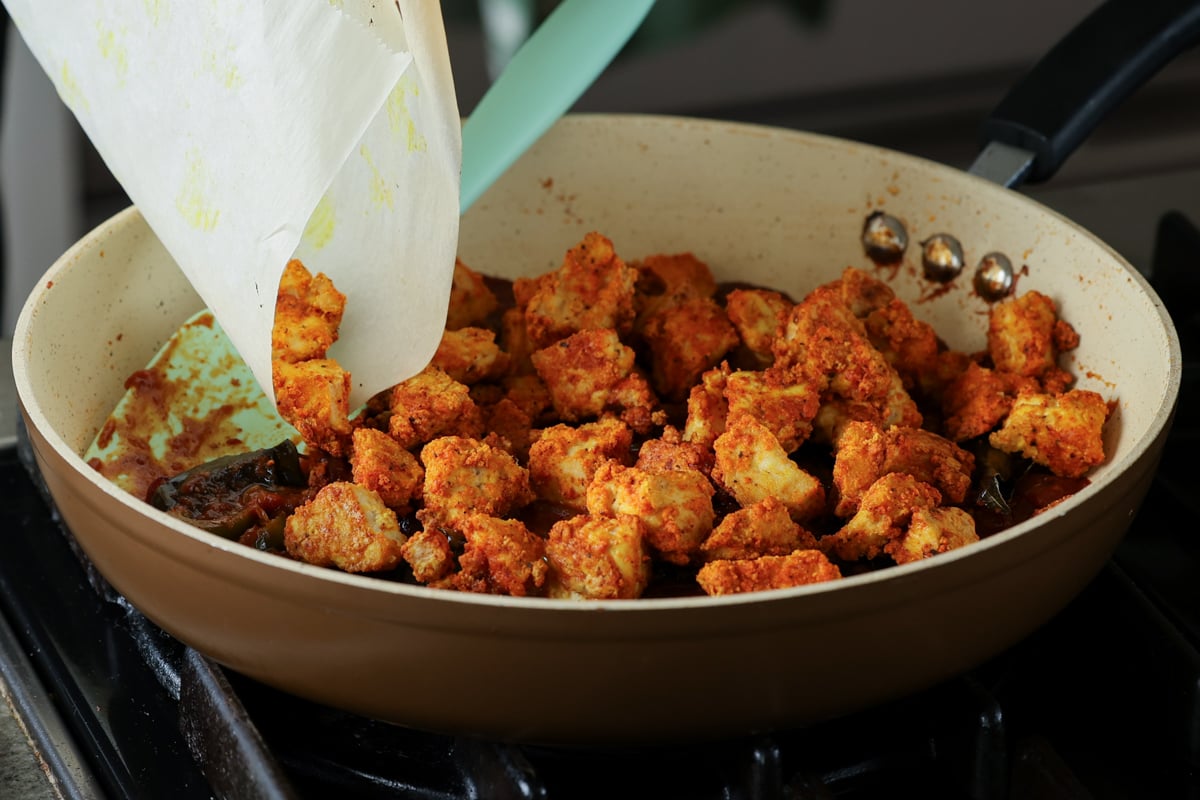 adding tofu to the kondattam sauce