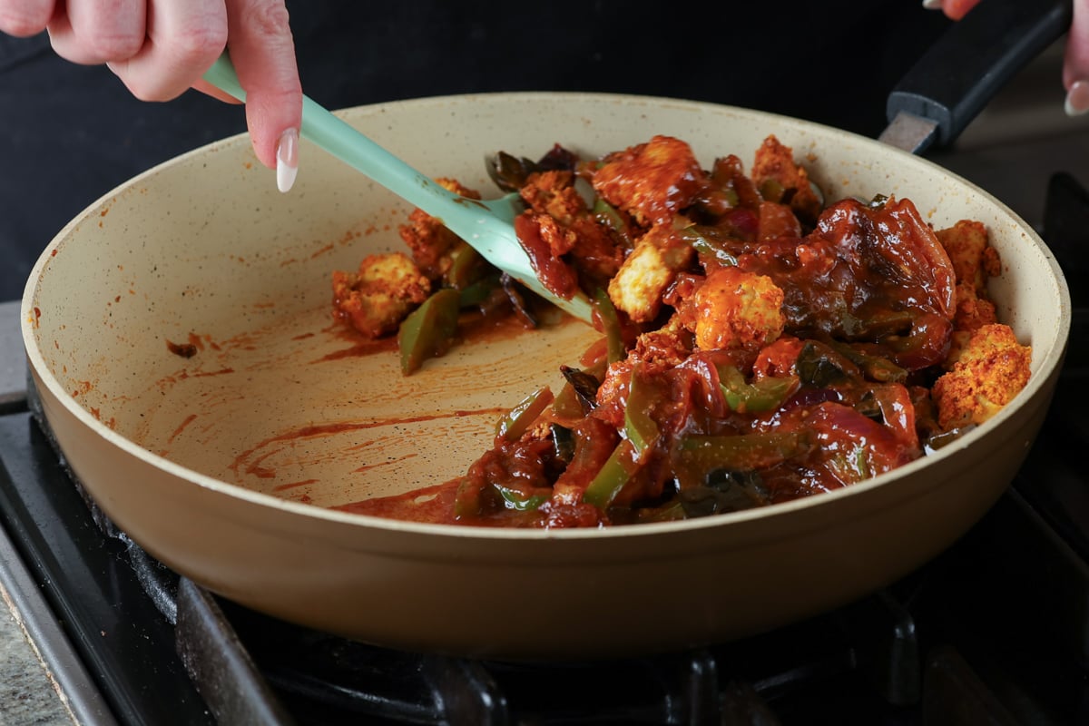mixing the tofu into the sauce