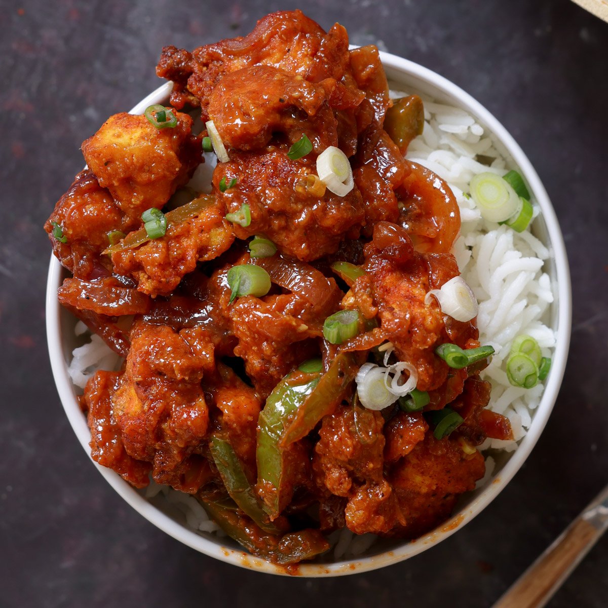 tofu kondattam in a bowl over rice