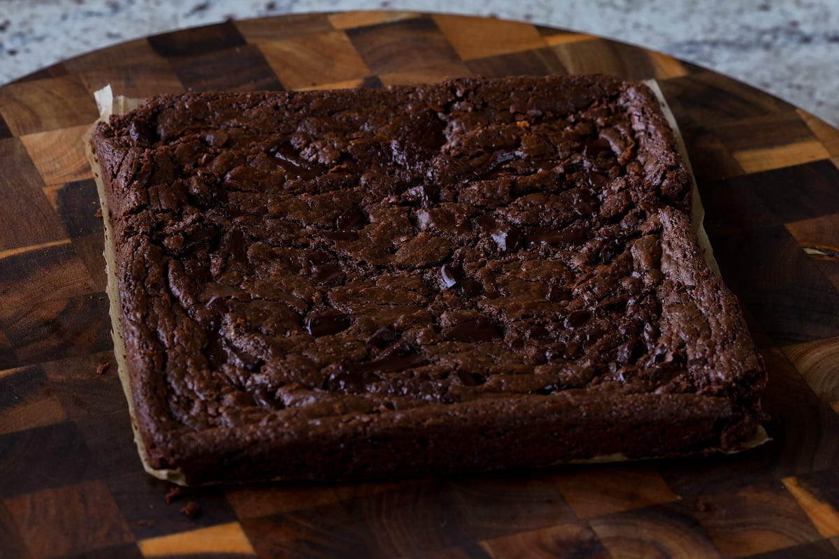 almond butter brownies cooling on a cutting board