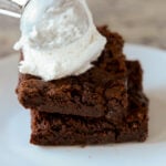 scooping ice cream onto the brownies