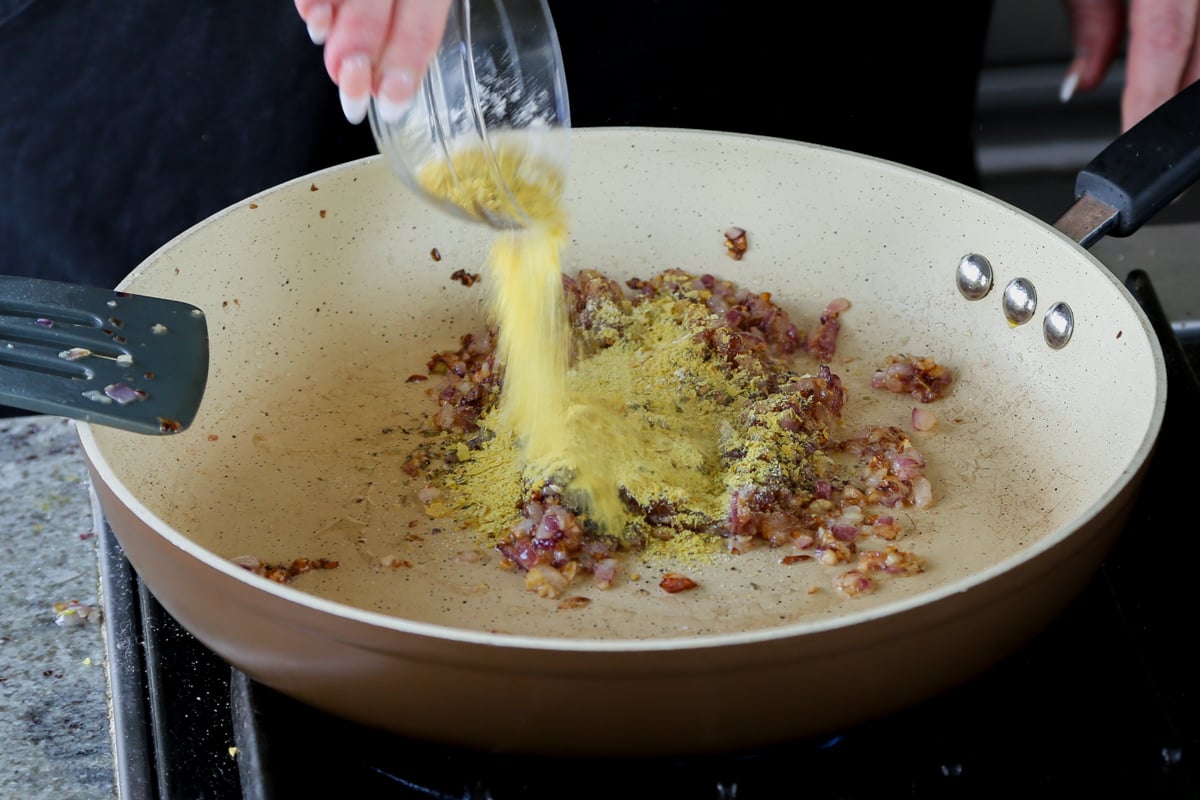 adding nutritional yeast to the pan