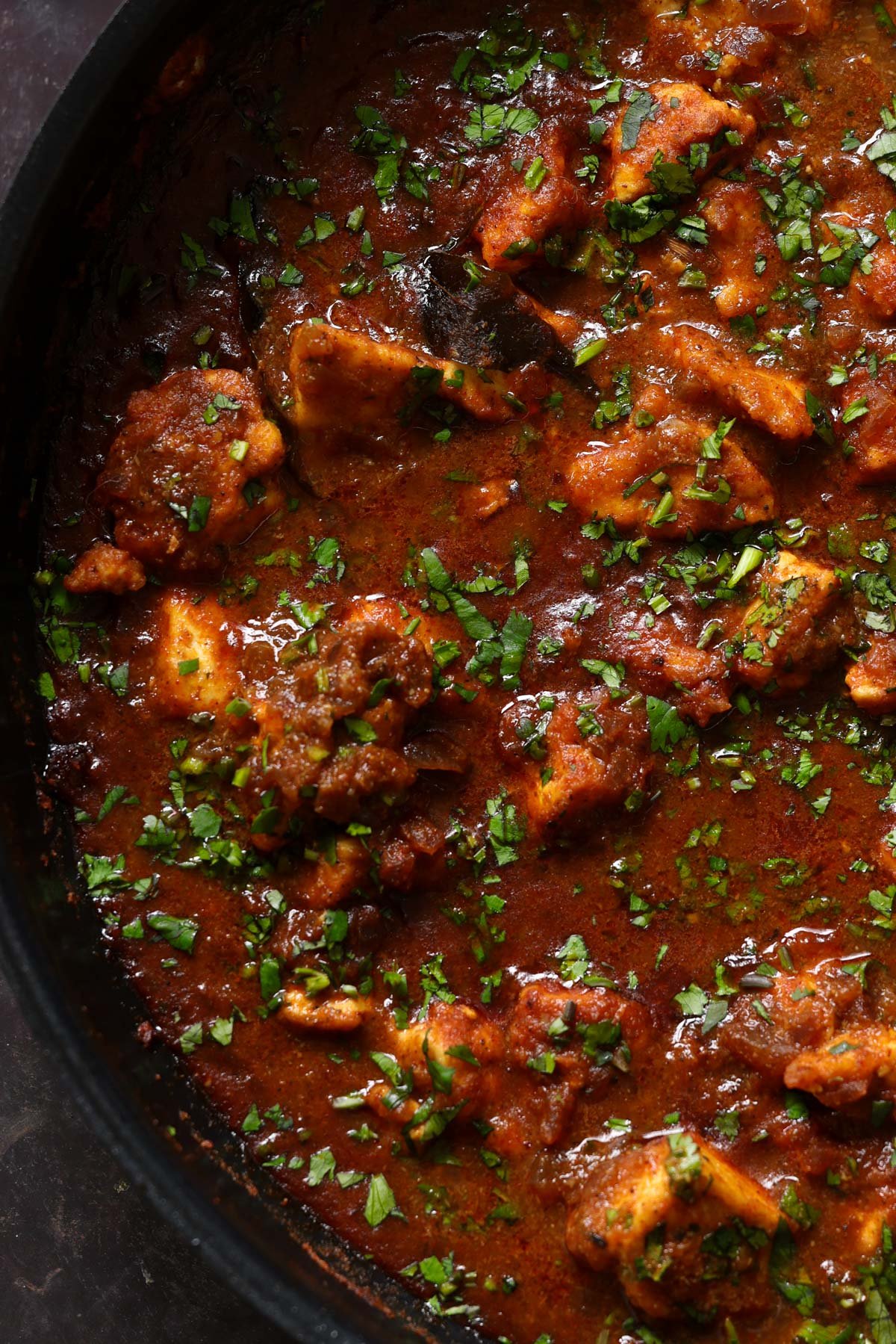 close-up of malvani chicken curry in the pan after cooking