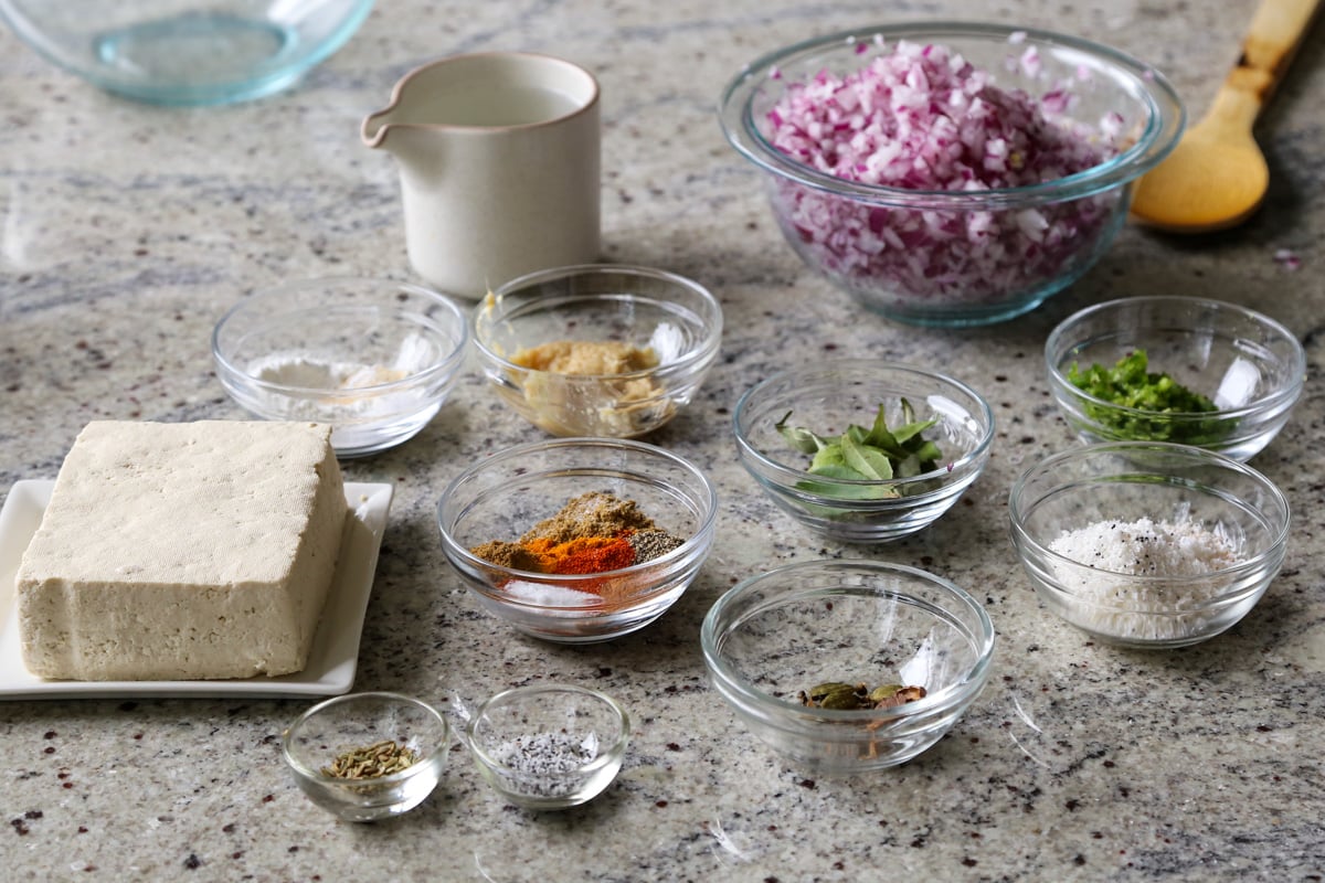 spices, tofu, and other curry ingredients in bowls on the kitchen counter