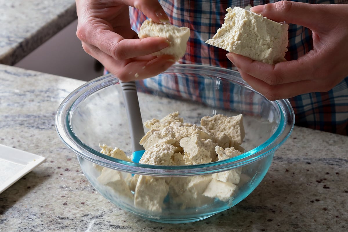 tearing up tofu into pieces