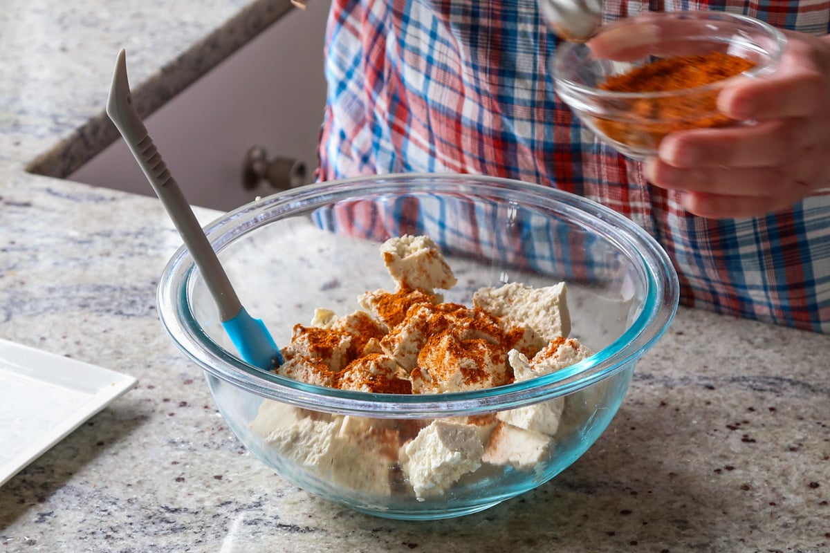 adding spice mixture to the tofu