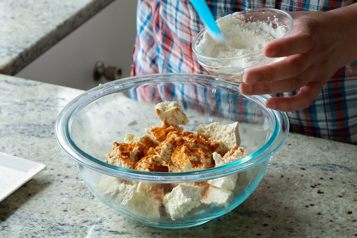 adding cornstarch to the tofu