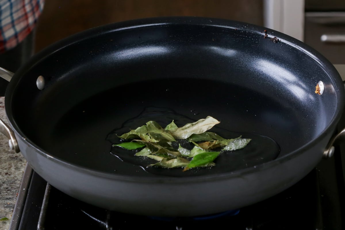 toasting curry leaves in the pan