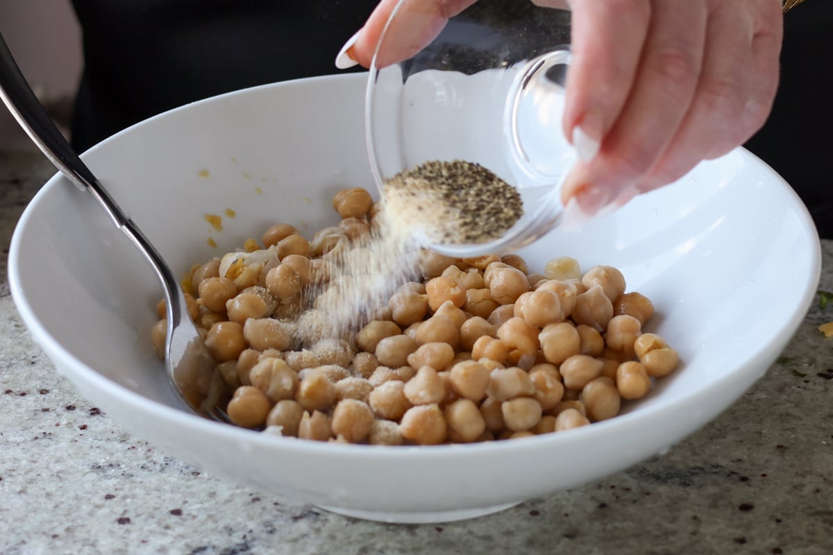 adding salty and spices to the chickpeas