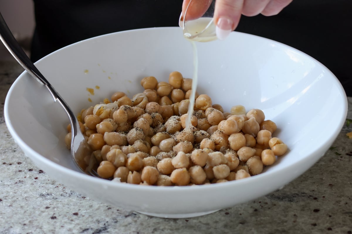adding lime juice to the chickpeas