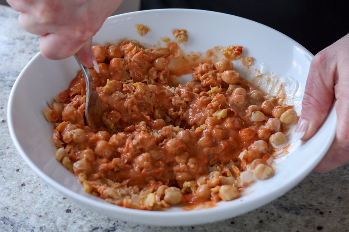 mashing the chickpeas with the seasonings